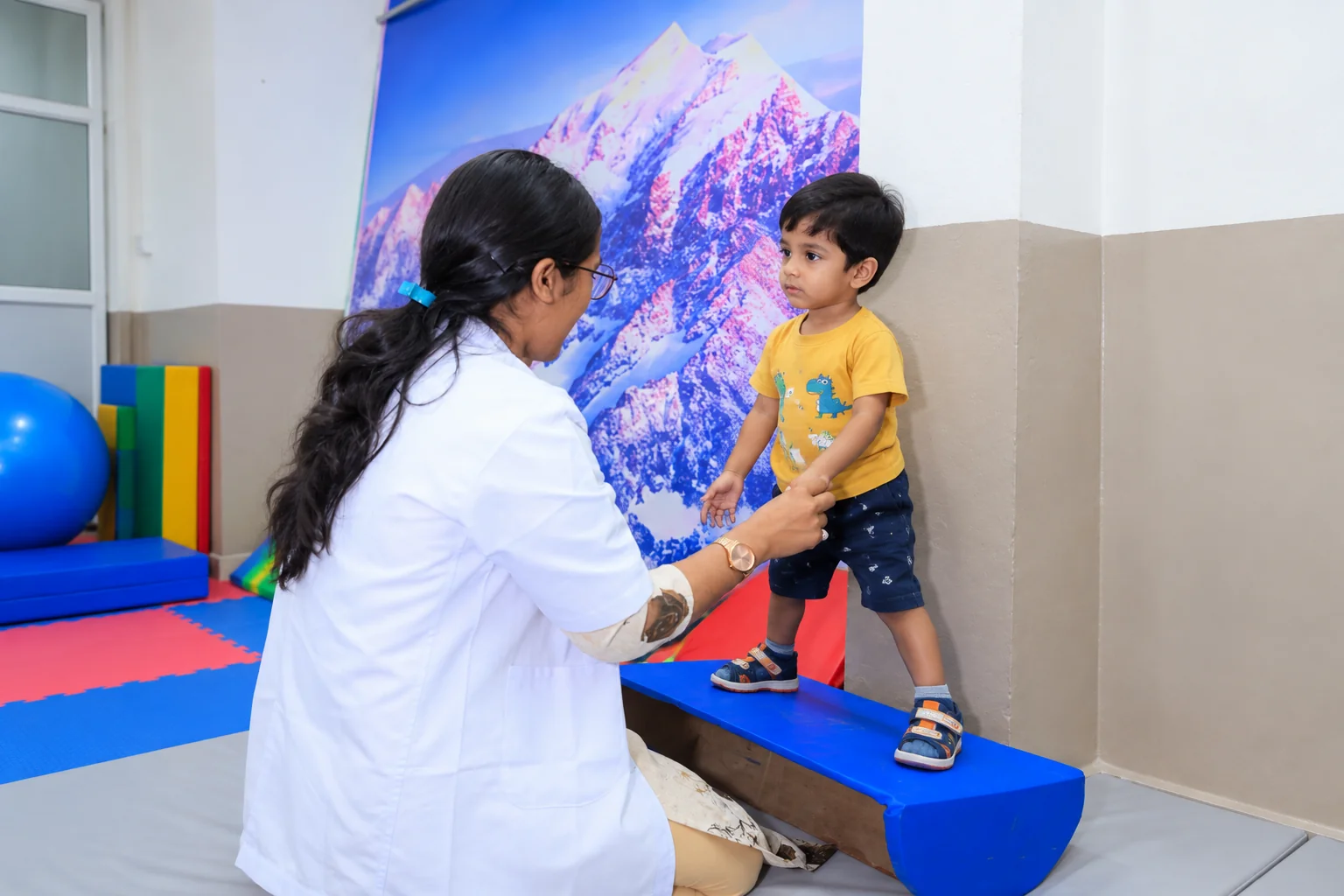 Child participating in an activity with a caregiver using adaptive seating