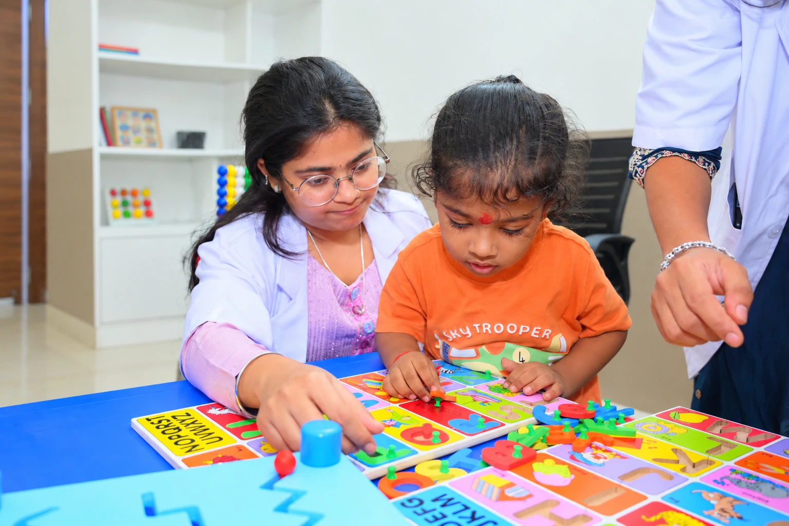 Caregiver and child gently engaged in a calm creative developmental activity together
